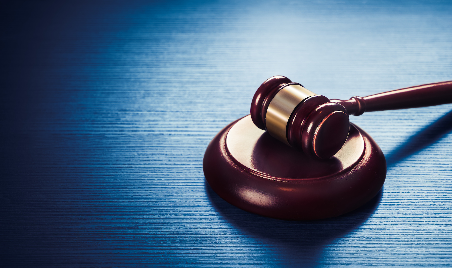 judge gavel on a blue wooden background Activist Legal Blog