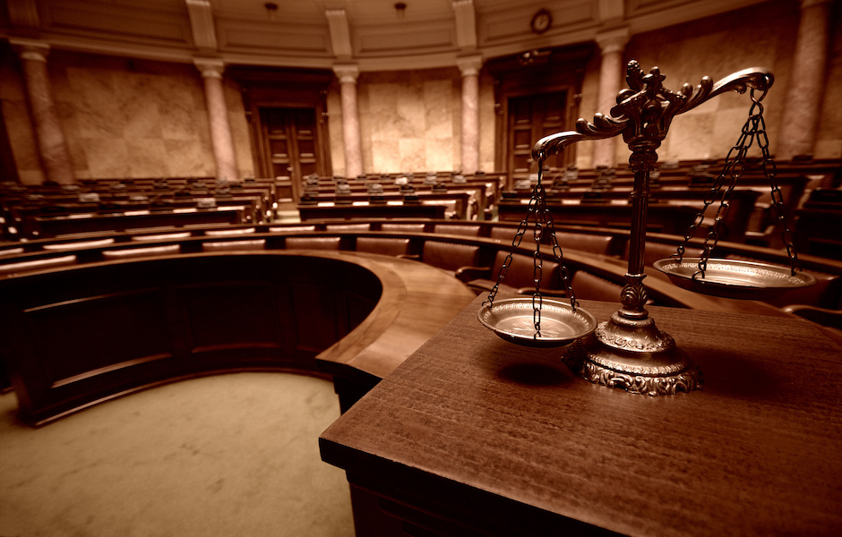 Decorative Scales of Justice in the Courtroom Litigation Firm Who Handles Default Services