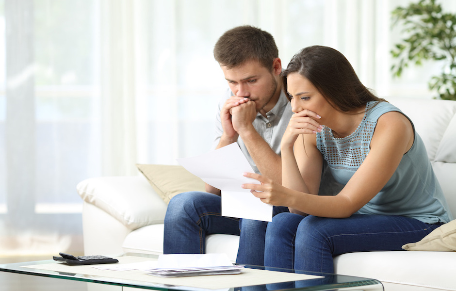 Worried couple reading a letter Foreclosure Law Firm